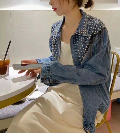 Loose fitting denim jacket with wicker fringe trim